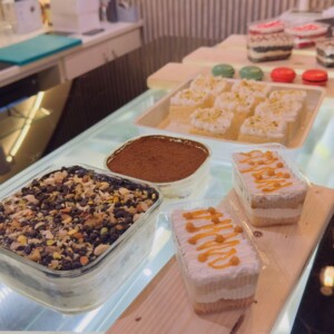 Layers of delight — Hi Café’s handcrafted sweet creations Gourmet dessert selection with chocolate, caramel, and whipped cream